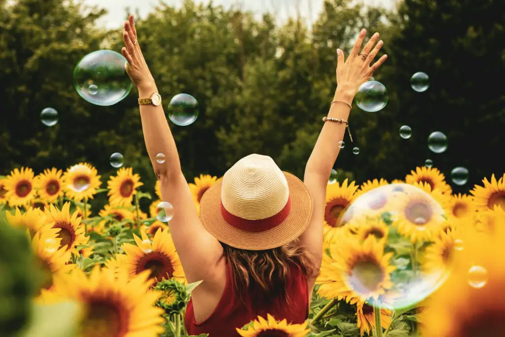 A lady Romanticizing her life in sunflowers and bubbles